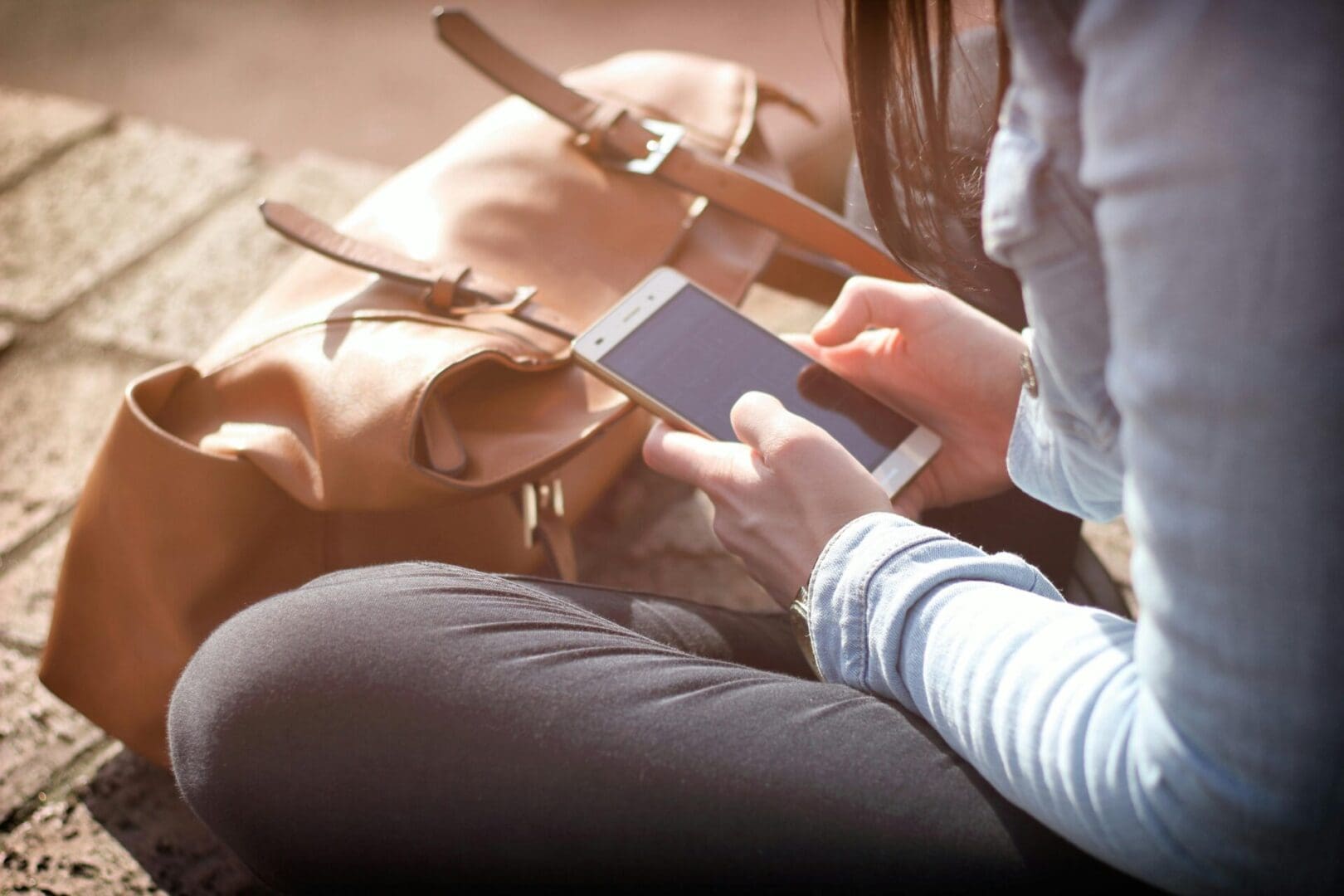 A person holding a cell phone in their hand.